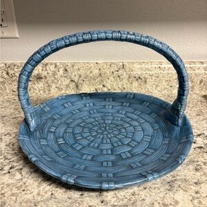 Decorative blue ceramic basket featuring a woven texture pattern and a handle